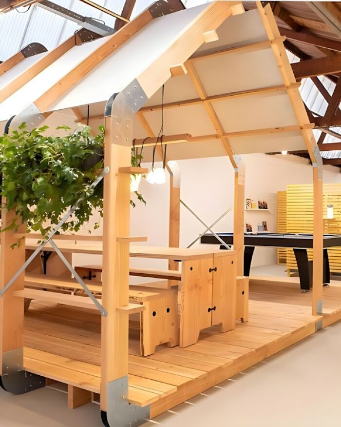 Estructura de madera con muebles integrados y plantas que demuestra habilidades en proyectos con madera modernos y funcionales.