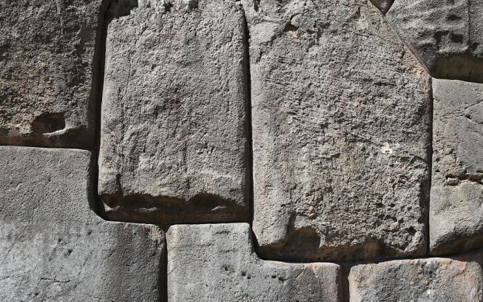 Close-up of ancient stone blocks with precise cuts, highlighting mysterious artifacts that baffle modern scientists.