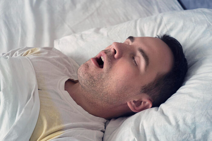 Man sleeping with mouth open, highlighting things guys discover in relationships.