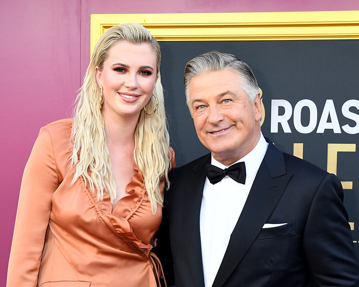 Man in a tuxedo and woman in a peach dress at a Hollywood event, symbolizing forgotten scandals in the industry.