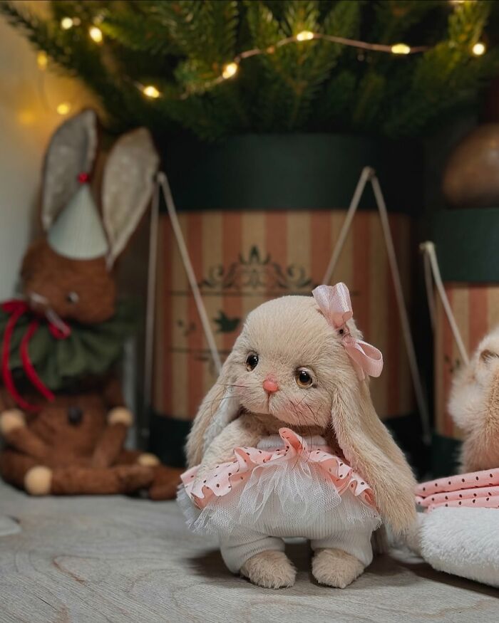 Whimsical plush toy rabbit with pink bow and tutu, handcrafted with care, set against a cozy background.