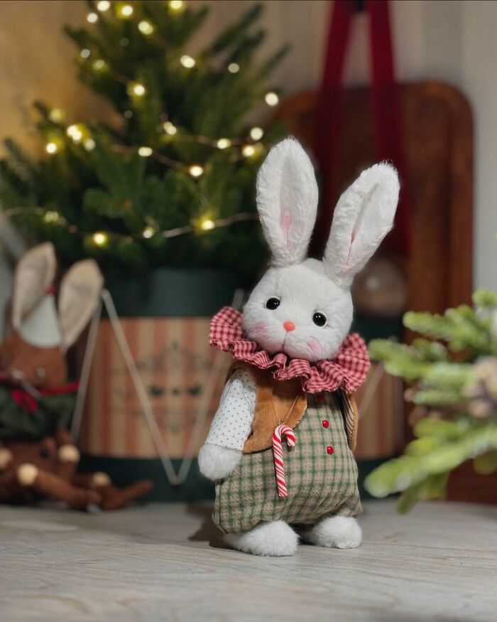Whimsical plush toy rabbit with checkered overalls and festive background.
