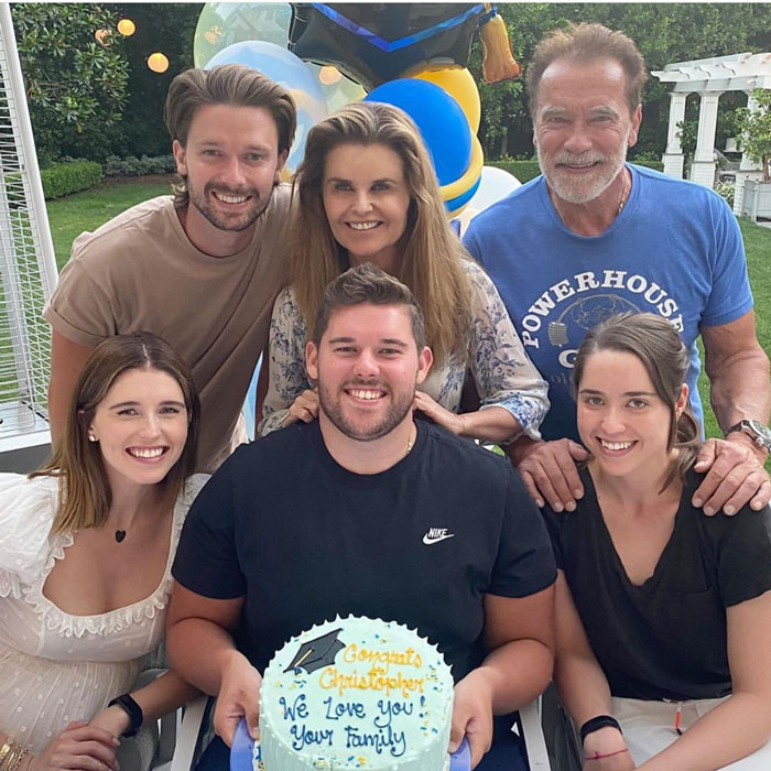 Family celebrating with Arnold Schwarzenegger’s son, holding a congratulatory cake for his impressive weight loss. Family celebrating with Arnold Schwarzenegger’s son, holding a congratulatory cake for his impressive weight loss.