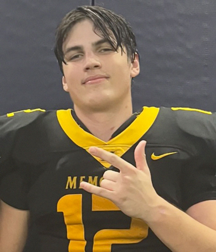 Teen in a black and gold jersey, with a solemn expression, symbolizing a heartbreaking moment.