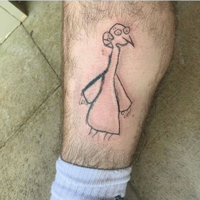 Simple sketch tattoo of a character on a leg, inspired by The Simpsons.