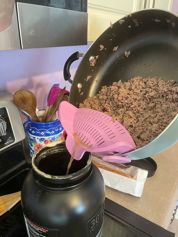 Ground beef drained from skillet using pink strainer, highlighting a kitchen tip for why Wednesday might not totally suck this week.