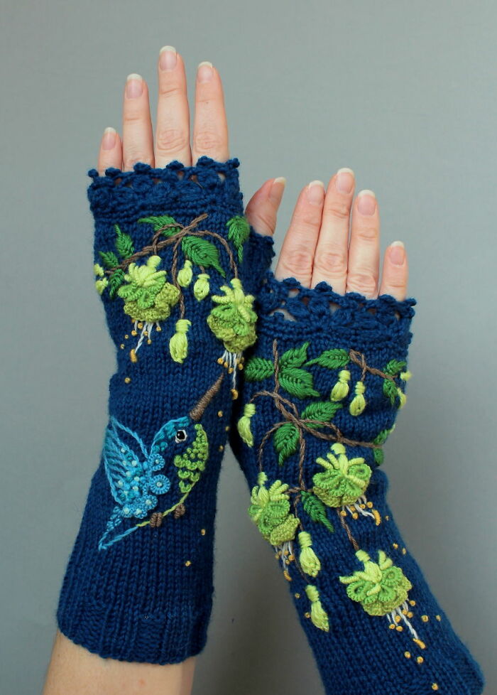 Embroidered fingerless gloves with a hummingbird and floral design on a blue background.