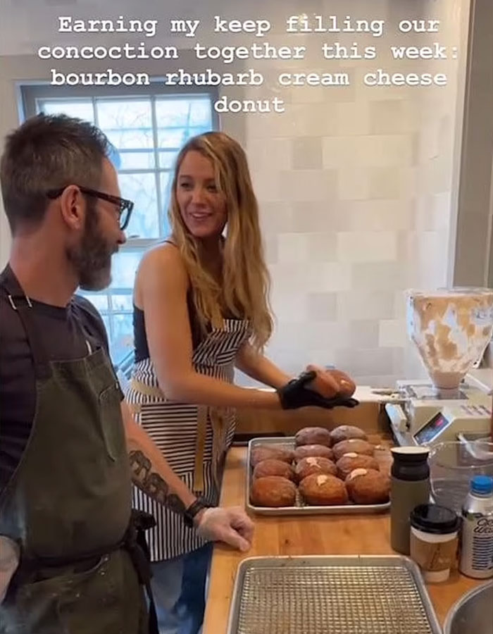 Person in apron with Blake Lively making donuts in a shop kitchen.