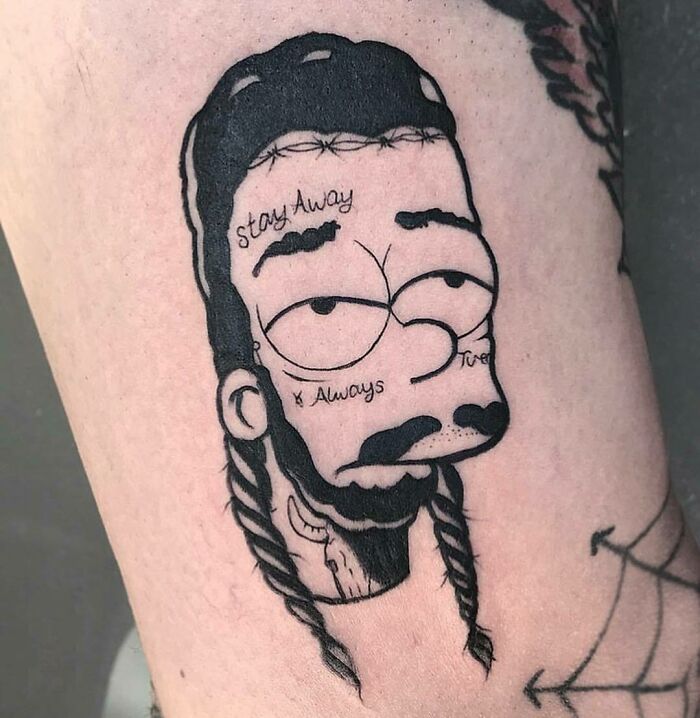 Simpsons tattoo of a character with braids and face tattoos on skin, blending cartoon and realistic styles.