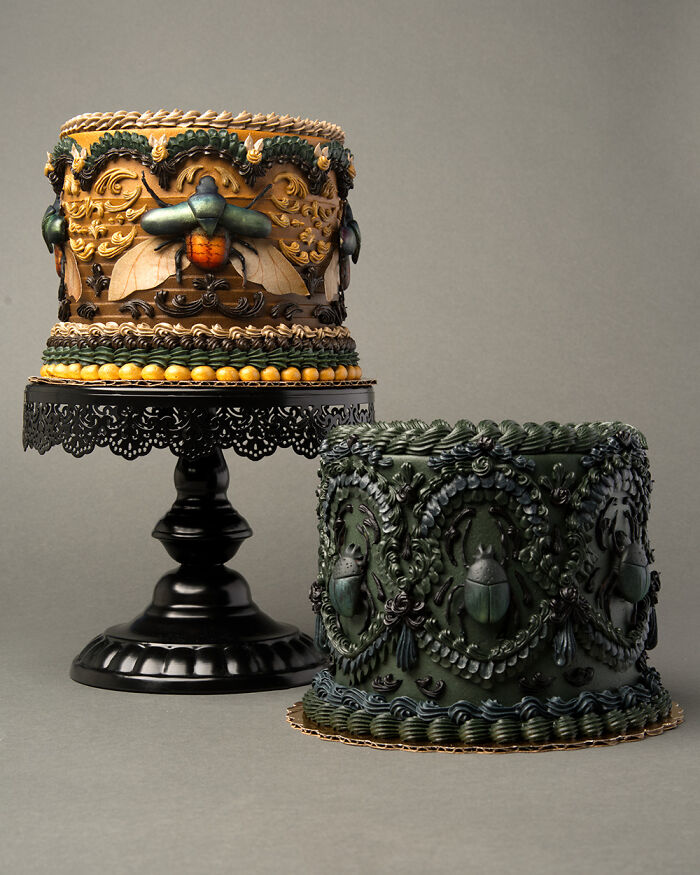 Two visually stunning cakes decorated with realistic bugs and slugs on ornate black stands.