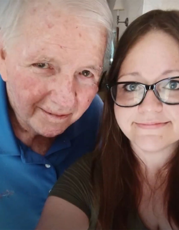 Elderly man in blue shirt and woman with glasses smiling, related to fertility fraud issue.