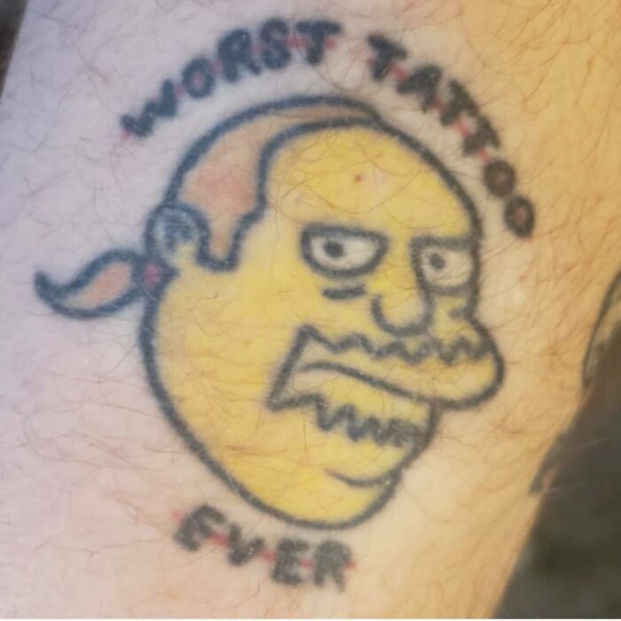 Yellow cartoon character tattoo with "Worst Tattoo Ever" text, referencing a humorous Simpsons design.