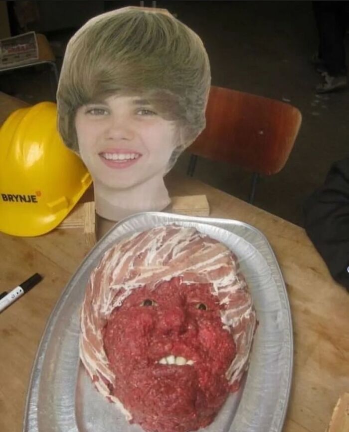 Cursed image of a meat face on a platter, with a cardboard celebrity cutout and a helmet on a table.