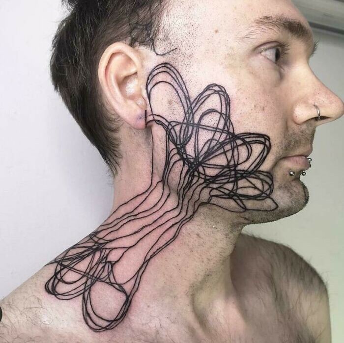 Man with abstract line tattoo covering face and neck, representing permanent ink mistakes.
