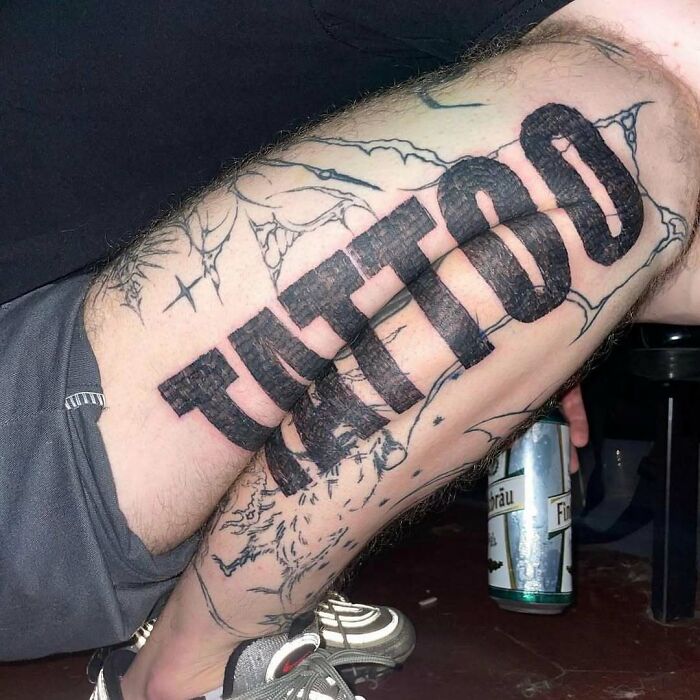 Tattoo inked boldly on a person's leg, surrounded by abstract designs, with a can in the background.