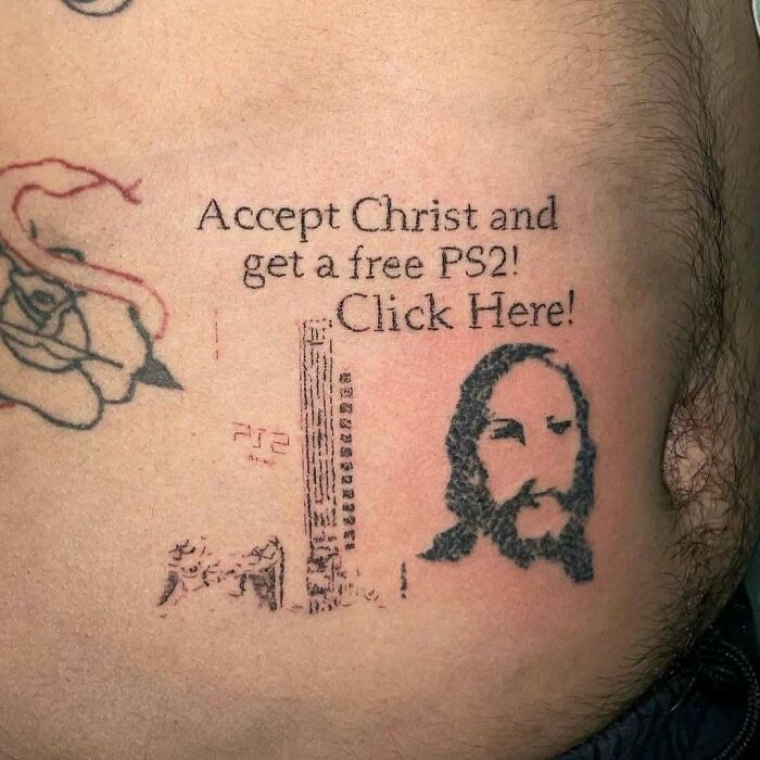 Tattoo with text: "Accept Christ and get a free PS2! Click Here!" with images of PS2, controller, and face.