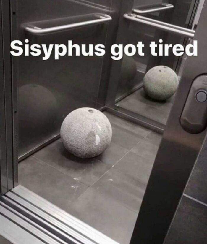Stone ball in elevator corner with text referencing Sisyphus, a meme for those who paid attention in history class.