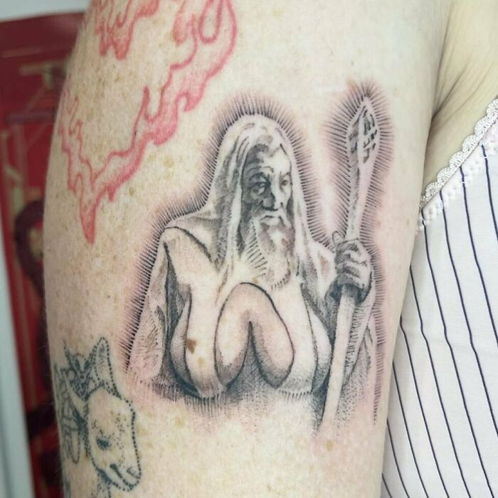 Wizard tattoo with exaggerated features on arm, highlighting permanent mistakes in body art.