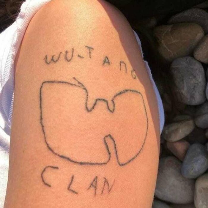 Poorly inked Wu-Tang Clan logo tattoo on an arm.