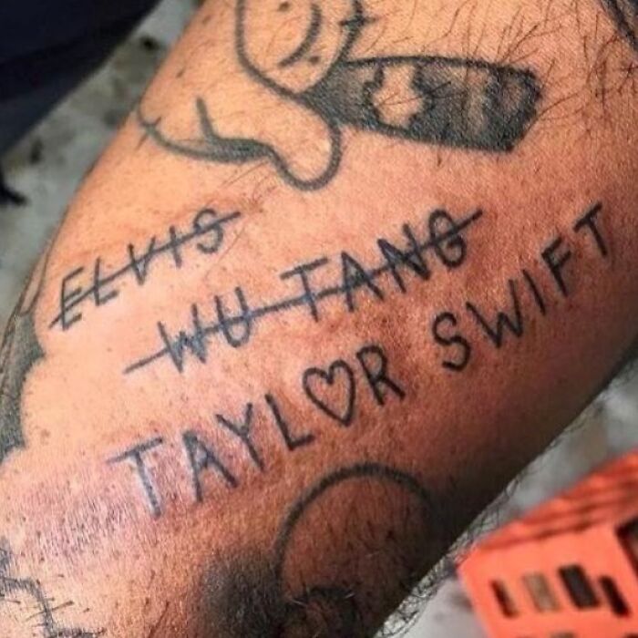 Tattoo of crossed-out names, highlighting common ink mistakes on the arm.