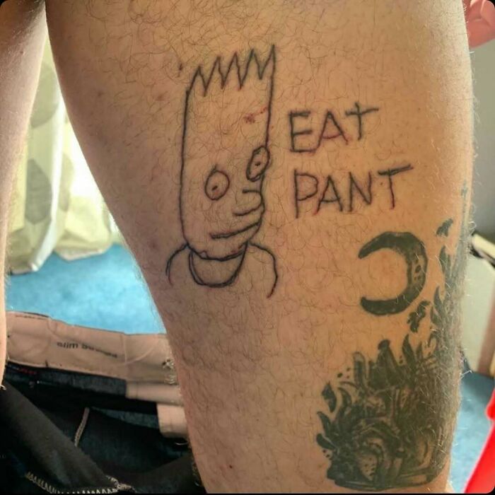 Amateur Simpsons tattoo of a character with "Eat Pant" text on someone's leg.