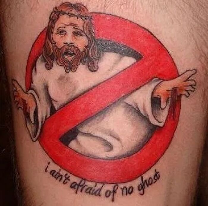 A tattoo of a religious figure with a red prohibition symbol, showcasing permanent ink mistakes.