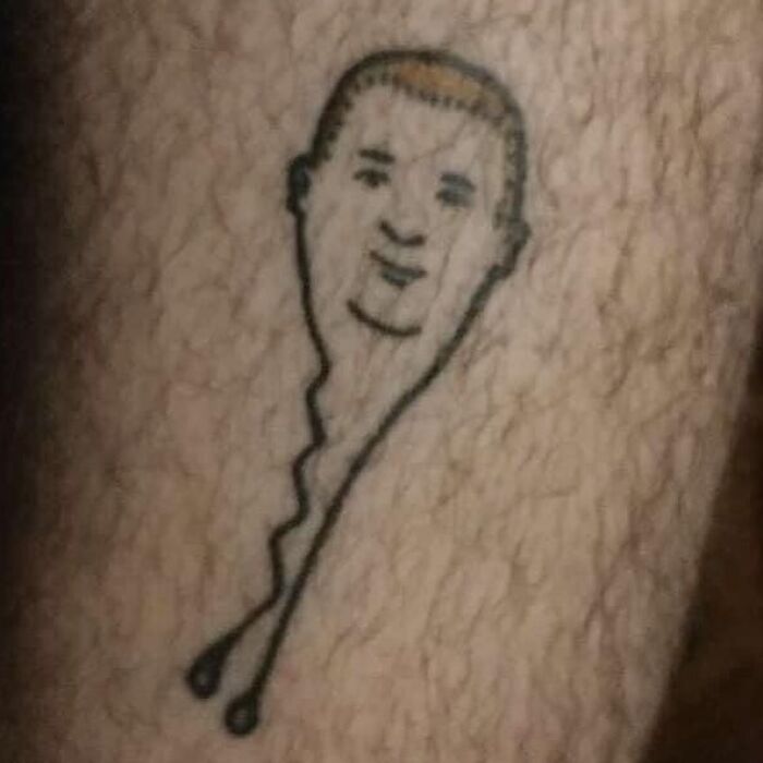 Bizarre tattoo inked on skin, featuring a balloon with a human face and string legs.