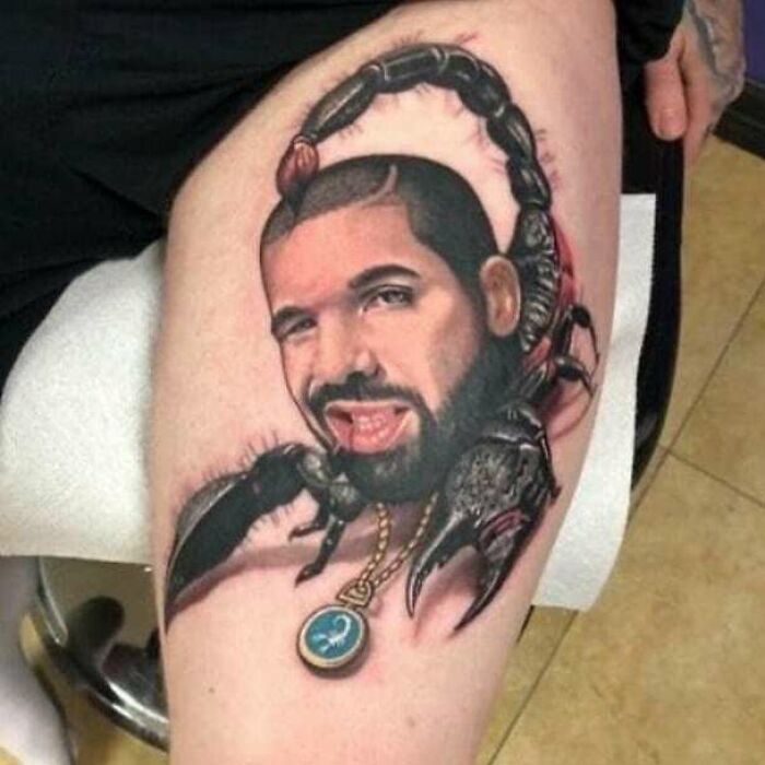 Person with tattoo depicting a scorpion with a face, possibly a permanent mistake in body art.