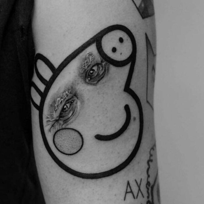 Tattoo mistake on arm with abstract face and real eyes, blending art and reality in a unique design.