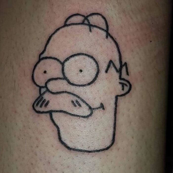 Minimalist Simpsons tattoo of a character on skin.