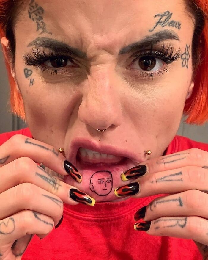 Person showing a hilariously bad tattoo inside their lip, part of the Body Art Museum collection.