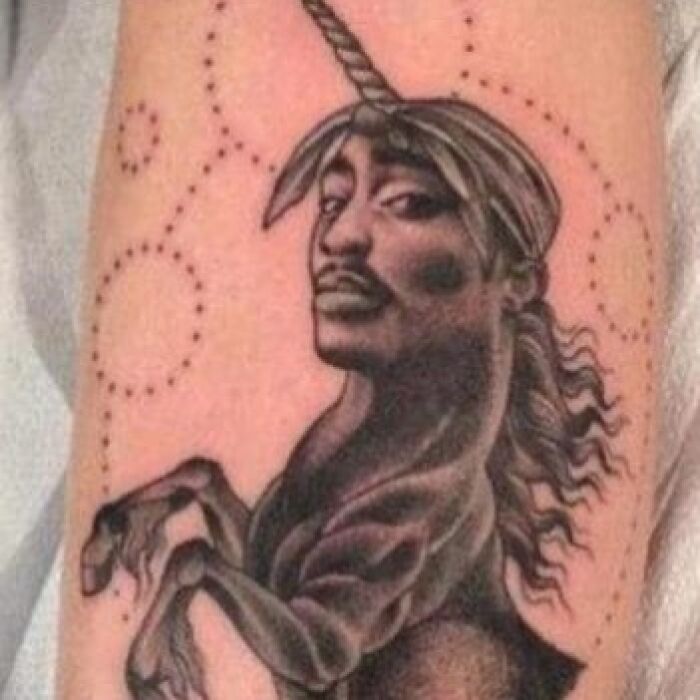 Tattoo of a unique unicorn with a person's face, illustrating a permanent mistake.