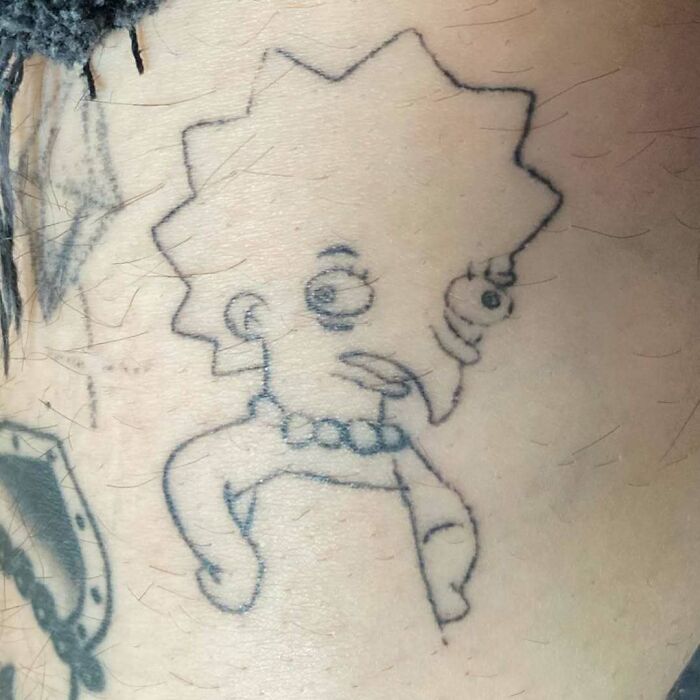 Unusual Simpsons tattoo with distorted character features on skin.