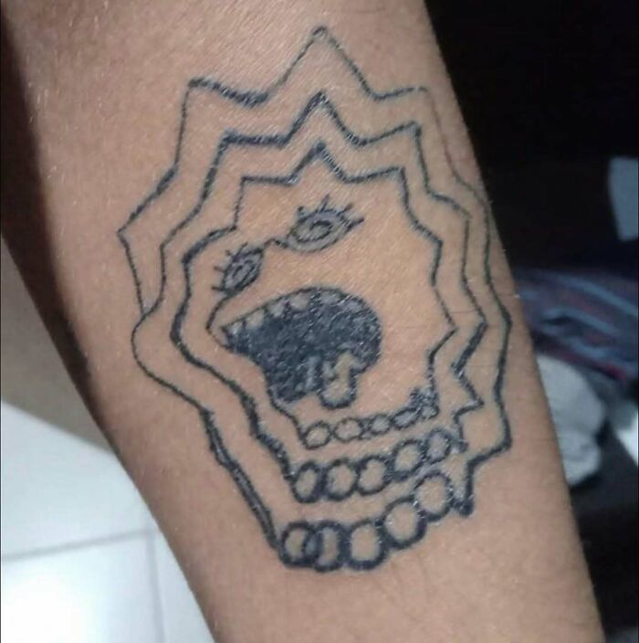 A poorly drawn Simpsons tattoo on an arm, with a jagged outline.