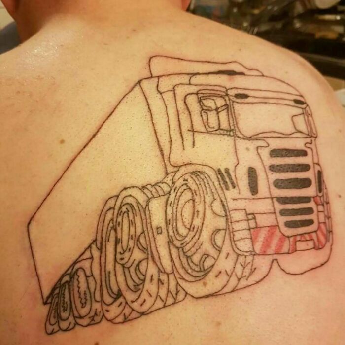 Tattoo of a large truck on a person's back with intricate wheel details, representing a permanent inked mistake.