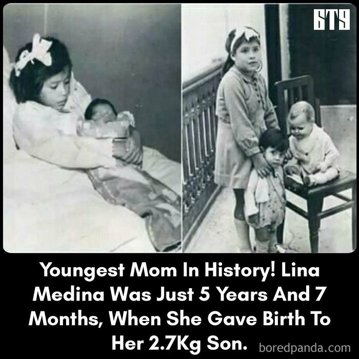 Young girl holding a baby, notable as one of the youngest mothers in history, in a black and white photograph.