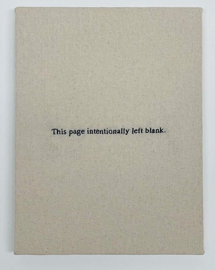 Embroidery art resembles a blank notebook page with text, "This page intentionally left blank."