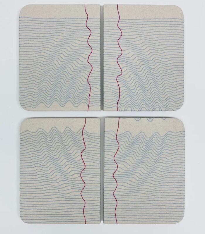 Fabric embroidered to resemble notebook pages with wavy lines and red stitching.