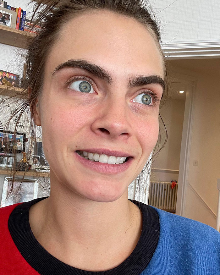 A person smiling in a casual setting, capturing a moment of transformation and sobriety praised at Coachella 2025.