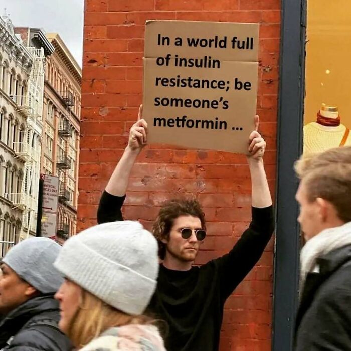 Person holds a cardboard sign reading, "In a world full of insulin resistance; be someone’s metformin," related to medical school memes.
