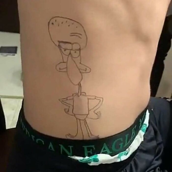 Tattoo of a cartoon character on someone's torso, showcasing a permanent ink mistake.
