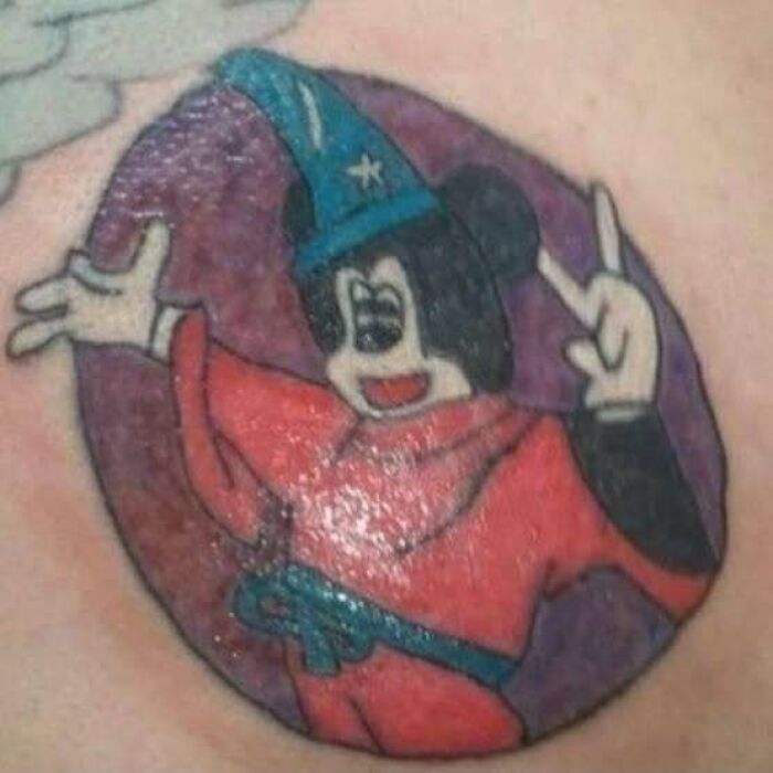Cartoon wizard character tattooed on skin, showcasing permanent ink mistakes.