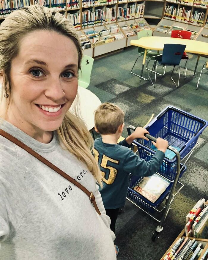 Smiling woman and child with shopping cart in library, illustrating moments from celebrity encounters that went either well or badly.