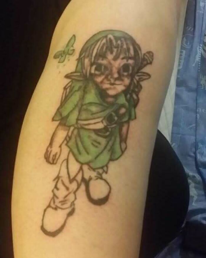 Cartoon character tattoo with a butterfly, showcasing a permanent ink mistake.