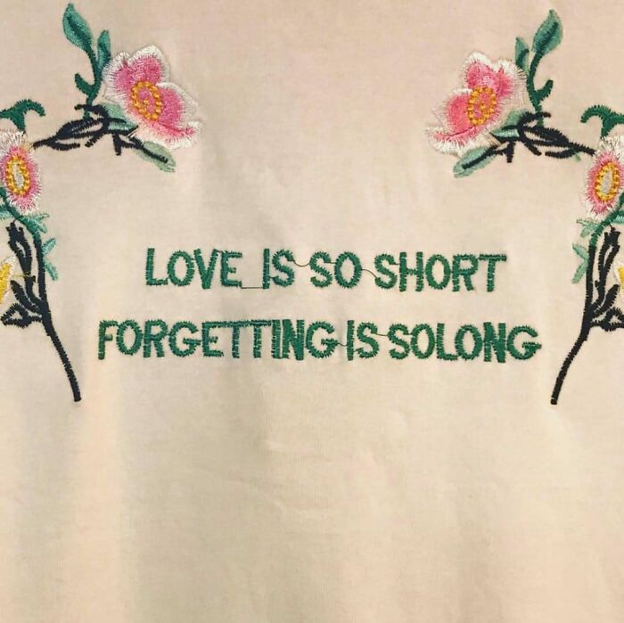T-shirt with humorous translation, floral design, saying "Love is so short, forgetting is so long."