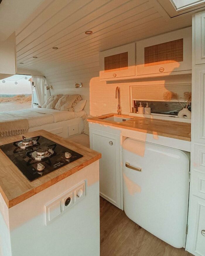 Cozy kitchen and sleeping area inside a clever and unique tiny home designed for life off the grid.