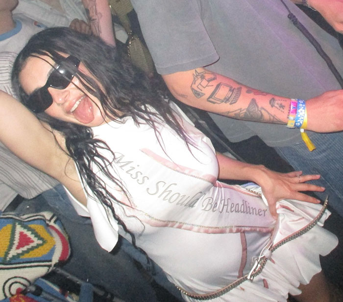 Festival-goer at Coachella 2025 wearing a "Miss Should Be Headliner" sash, embodying viral and awkward moments.