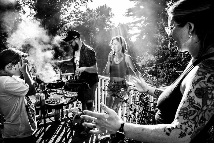 A rural Maine family enjoying a smoky barbeque moment, captured in intimate detail by Barbara Peacock.