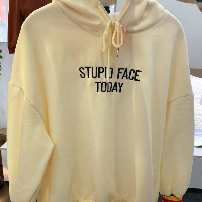 Cream hoodie with "Stupid Face Today" text, humorously lost in translation.