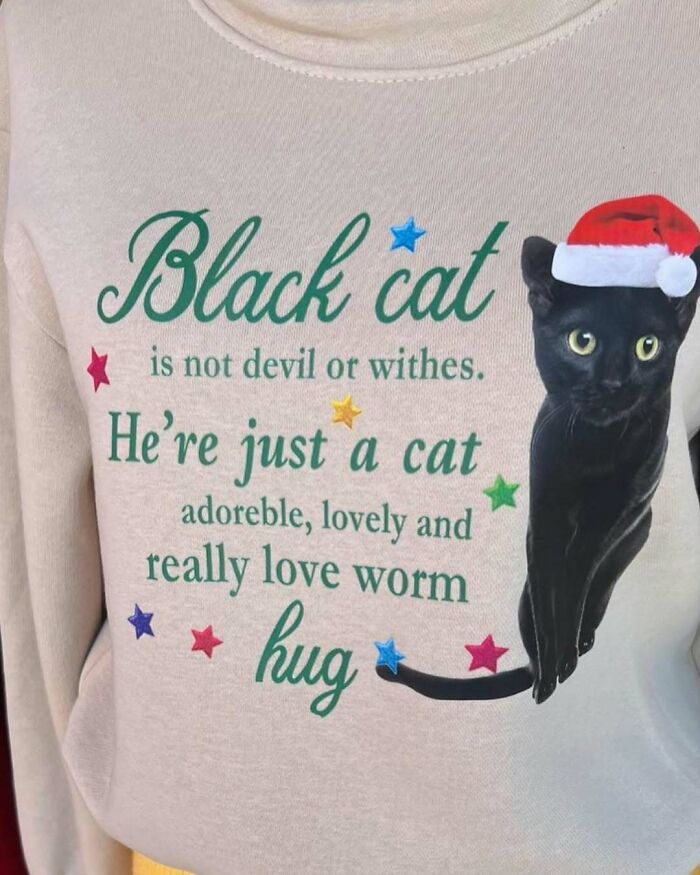 T-shirt with humorously mistranslated black cat text, featuring a festive cat wearing a Santa hat.